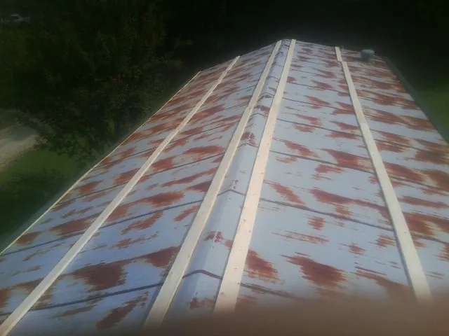 Rusted metal roof panels with new wood purlins before replacement — Storm Damage Roof Repair in Parkton by Roofing Brothers